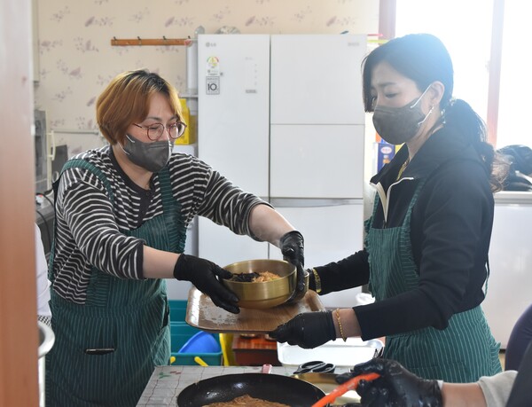 이날 점심나눔 봉사 참여자들이 음식을 전달하고 있다.